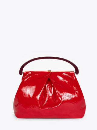 Image is of a red patent handbag from Dries Van Noten